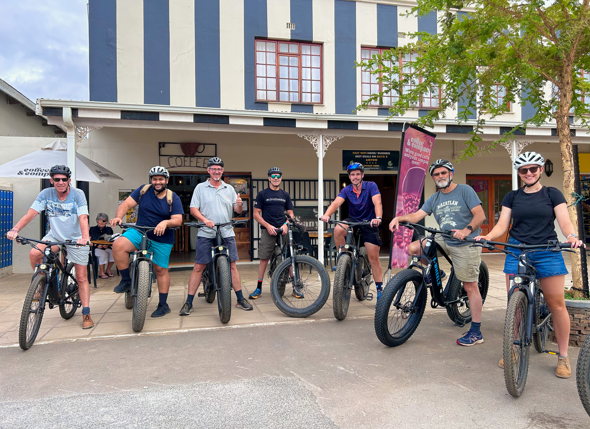 A group of riders on e-bikes outside Coffee & Company in Bonnievale before a Vineyard Tale