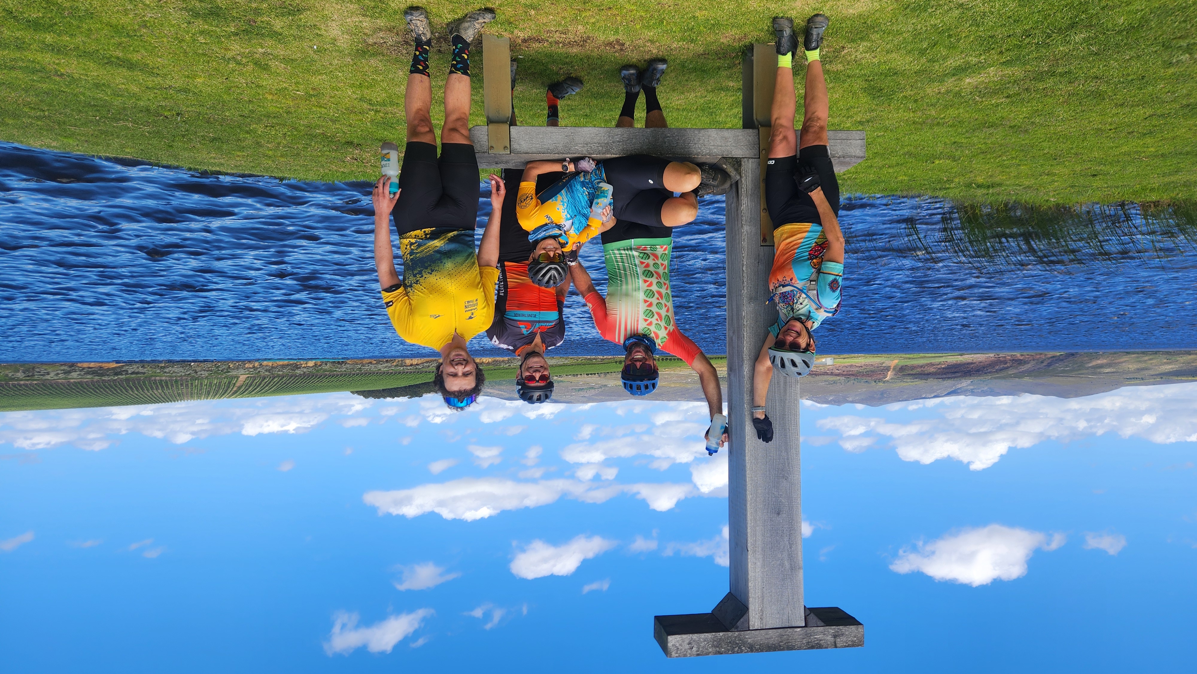 Cyclists at a dam on the Overberg Xplore gravel adventure