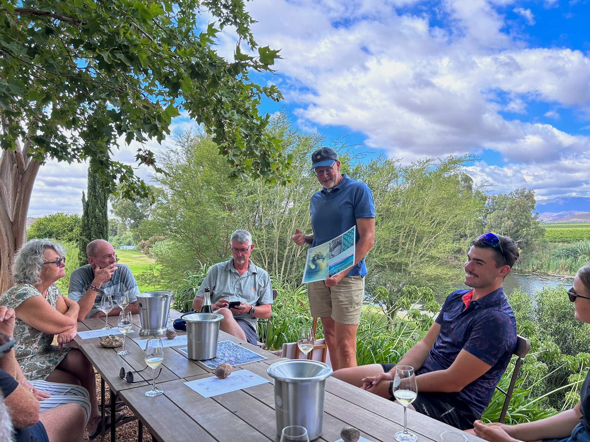 Riders seated around a table for a tasting on a Breede River Valley wine farm